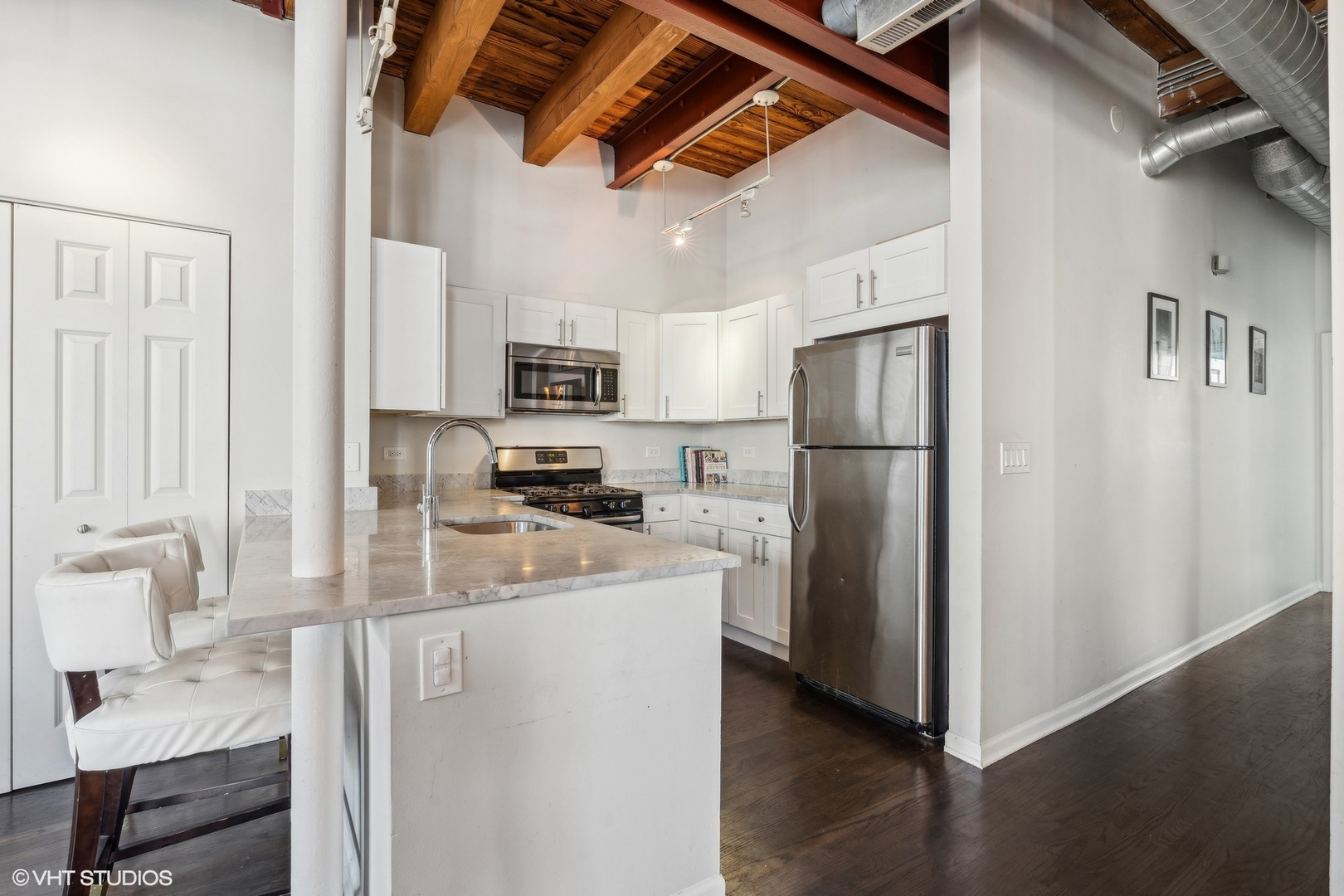 1235 West George Street, Unit 215 Chicago, IL 60657 - Photo 10 of 25 a kitchen with stainless steel appliances a refrigerator and a stove top oven