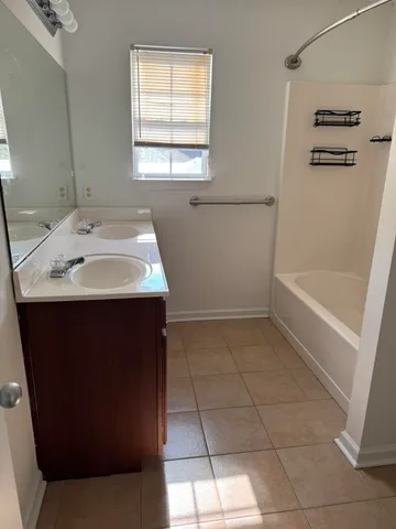 a bathroom with a sink a vanity and a bathtub