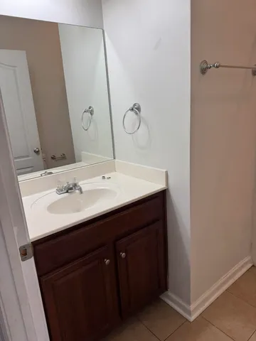 a bathroom with a double vanity sink and mirror