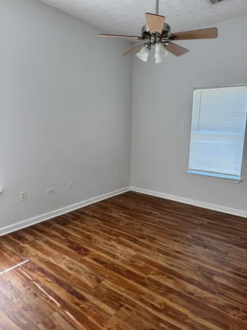 a view of a room with an empty space and a ceiling fan
