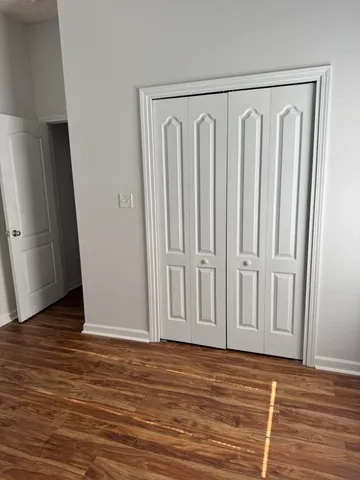 a view of a door with wooden floor