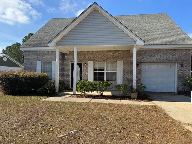a front view of a house with a yard