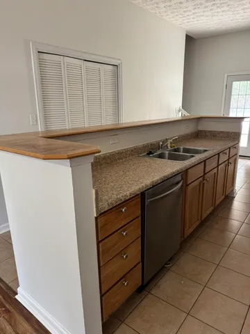 a kitchen with granite countertop a stove and a sink