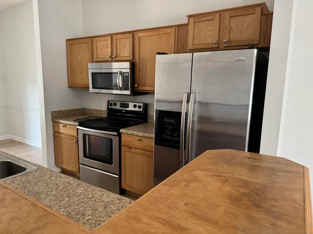 a kitchen with a refrigerator stove and microwave