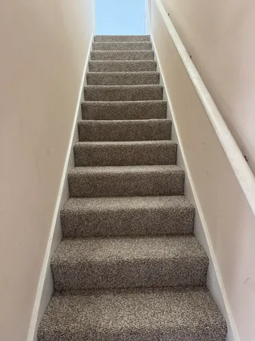 a view of staircase with white walls
