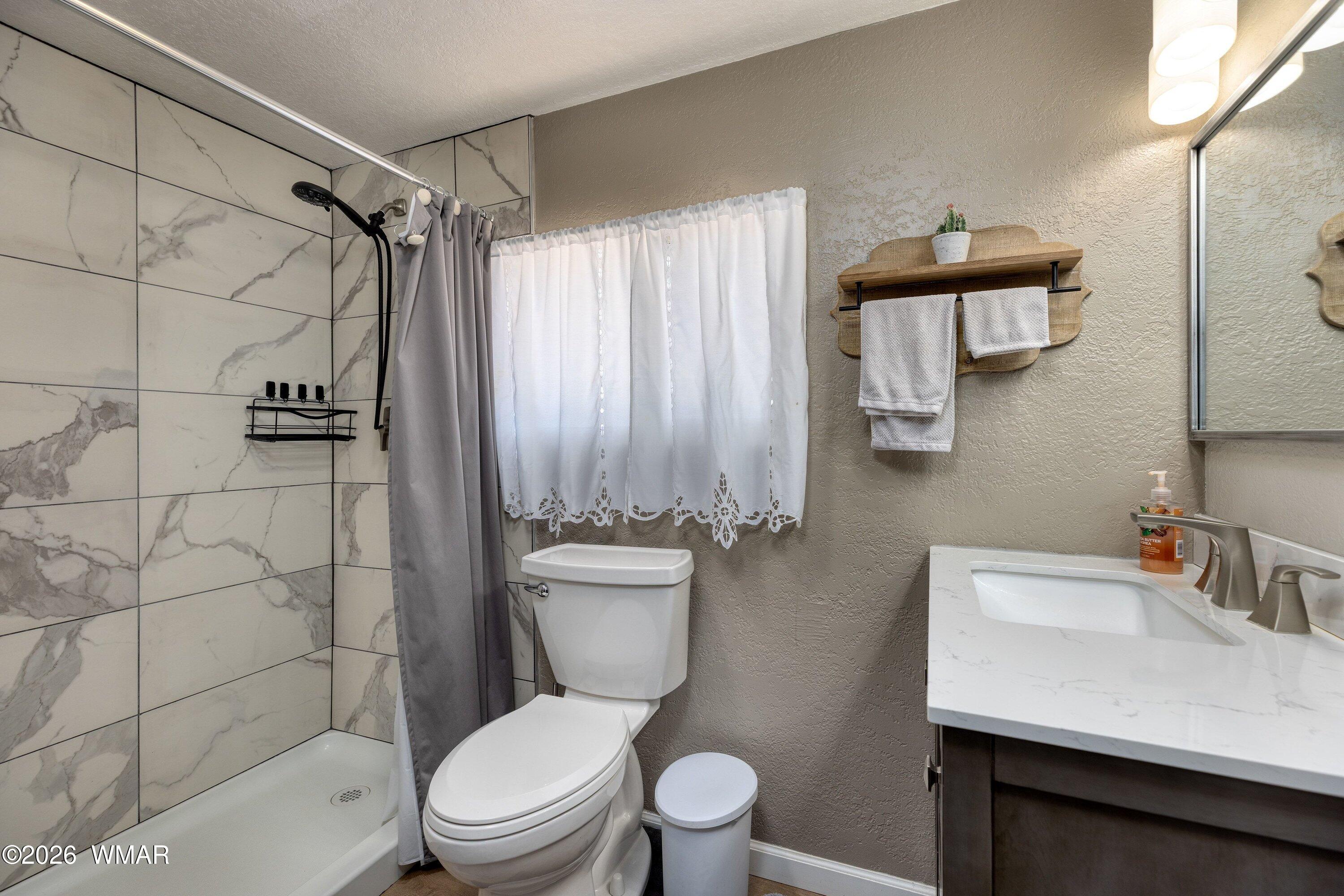 1114 Ranch Road Taylor, AZ 85939 - Photo 24 of 32 a white toilet sitting next to a bathroom sink