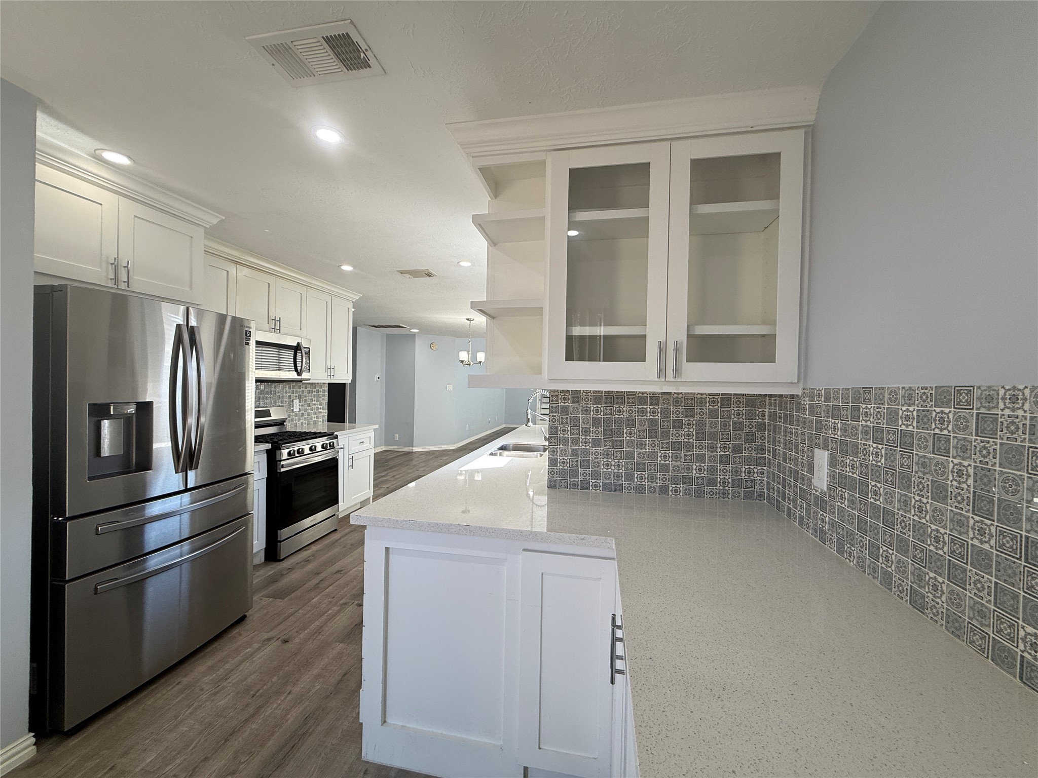 19614 Azalea Valley Drive Katy, TX 77449 - Photo 11 of 27 a kitchen with cabinets and stainless steel appliances