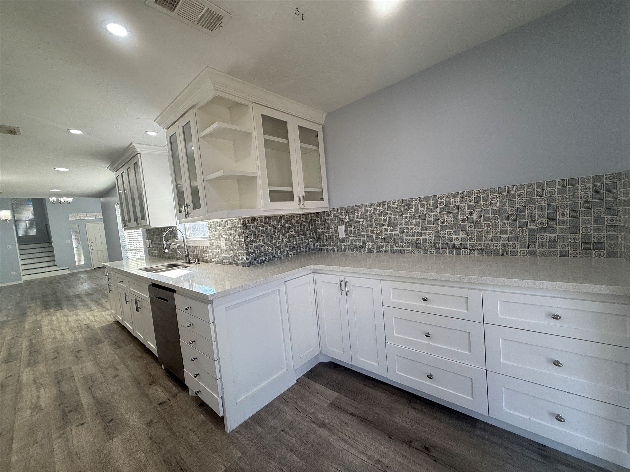 19614 Azalea Valley Drive Katy, TX 77449 - Photo 13 of 27 a kitchen with granite countertop white cabinets and white stainless steel appliances