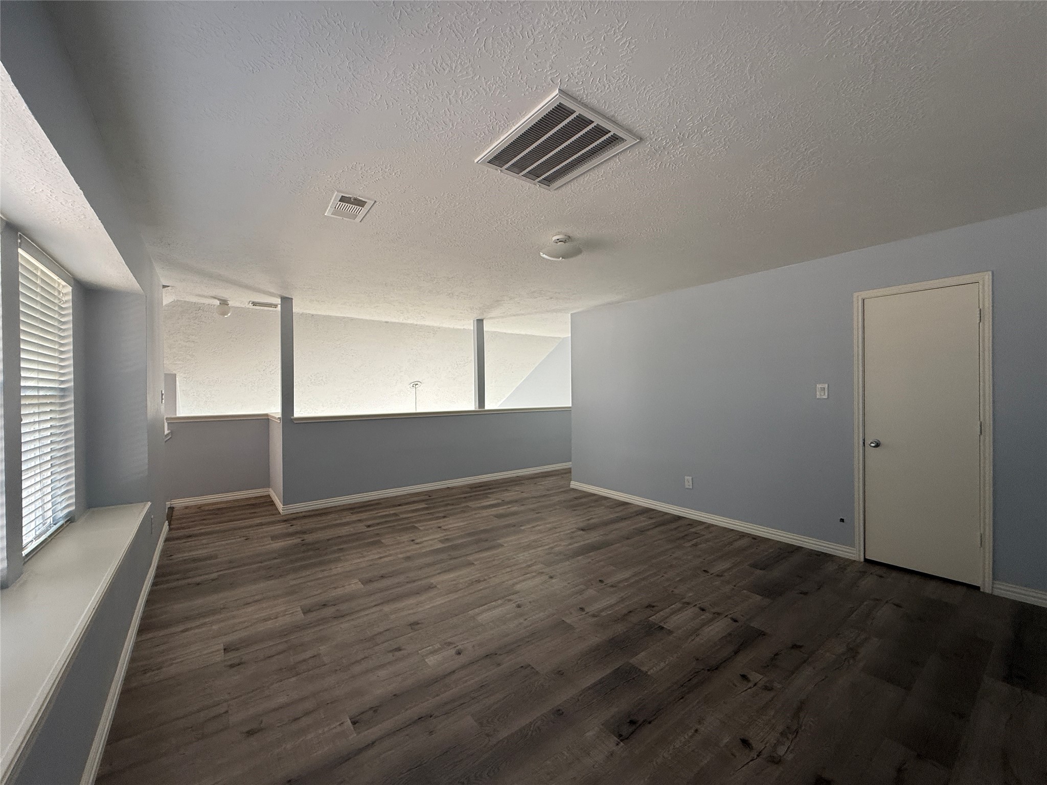 19614 Azalea Valley Drive Katy, TX 77449 - Photo 20 of 27 an empty room with wooden floor and windows