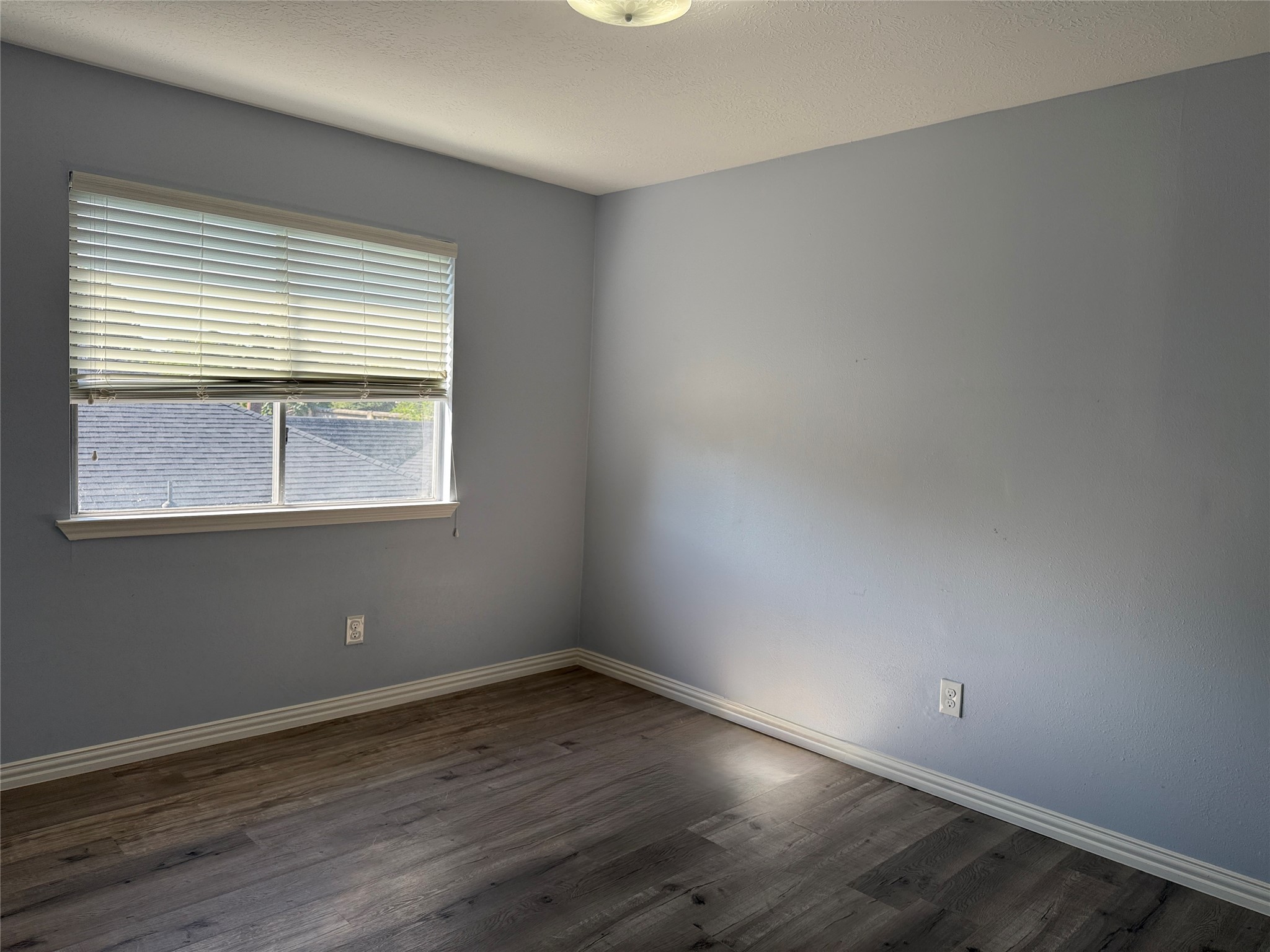 19614 Azalea Valley Drive Katy, TX 77449 - Photo 22 of 27 wooden floor and window in an empty room