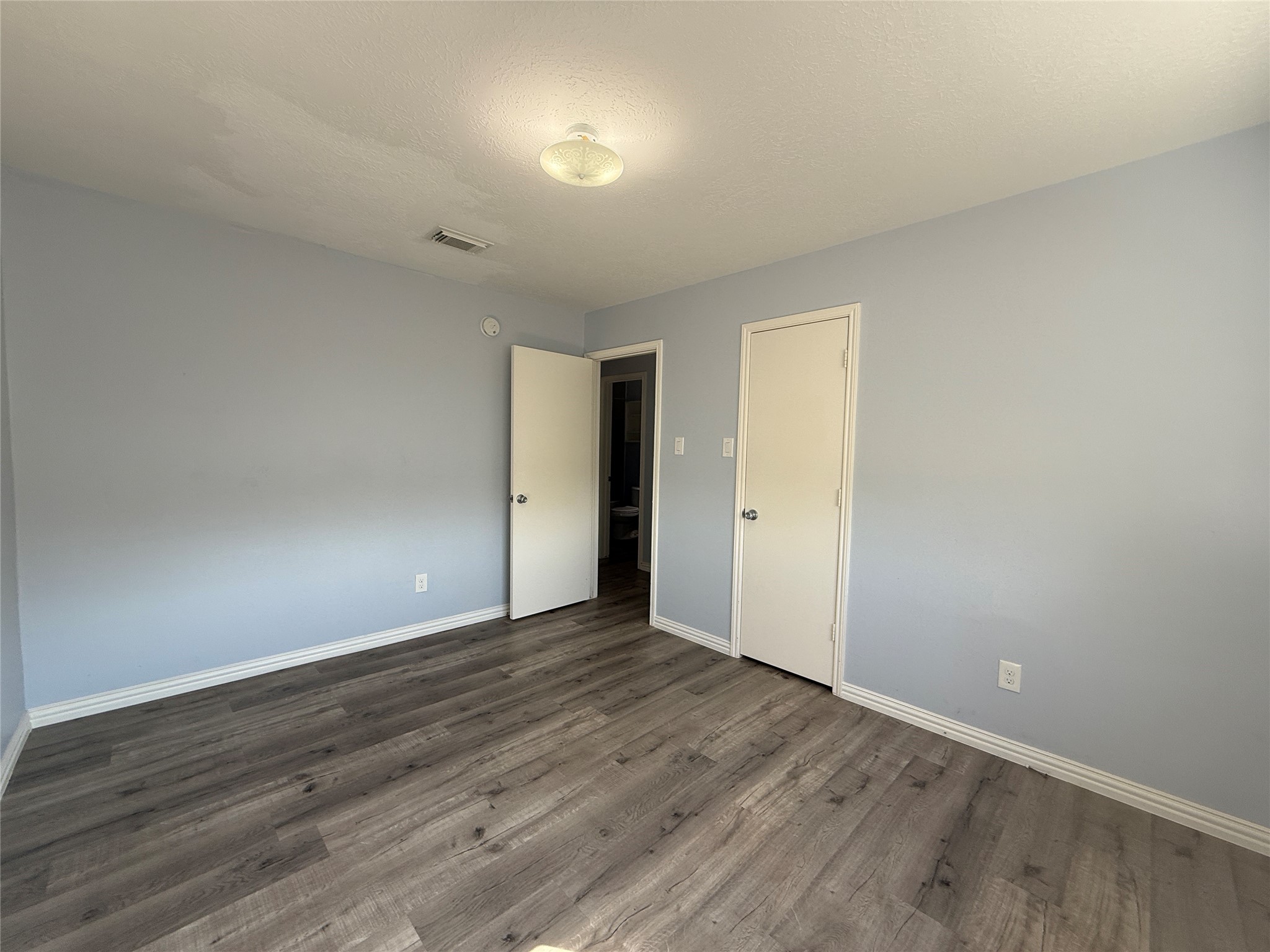 19614 Azalea Valley Drive Katy, TX 77449 - Photo 25 of 27 a view of an empty room with wooden floor