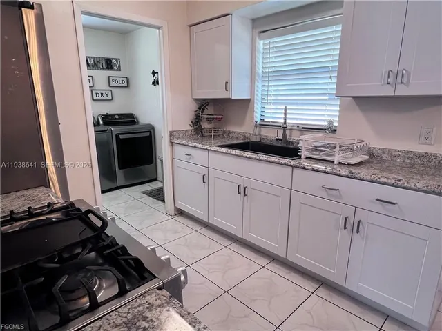 a kitchen with granite countertop a stove and a sink