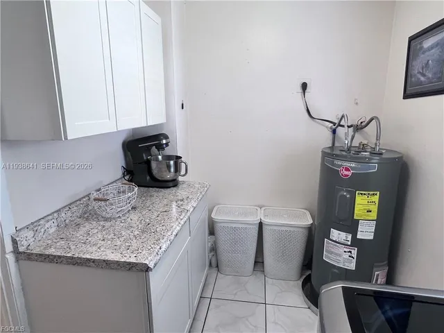 a bathroom with a granite countertop toilet sink and mirror