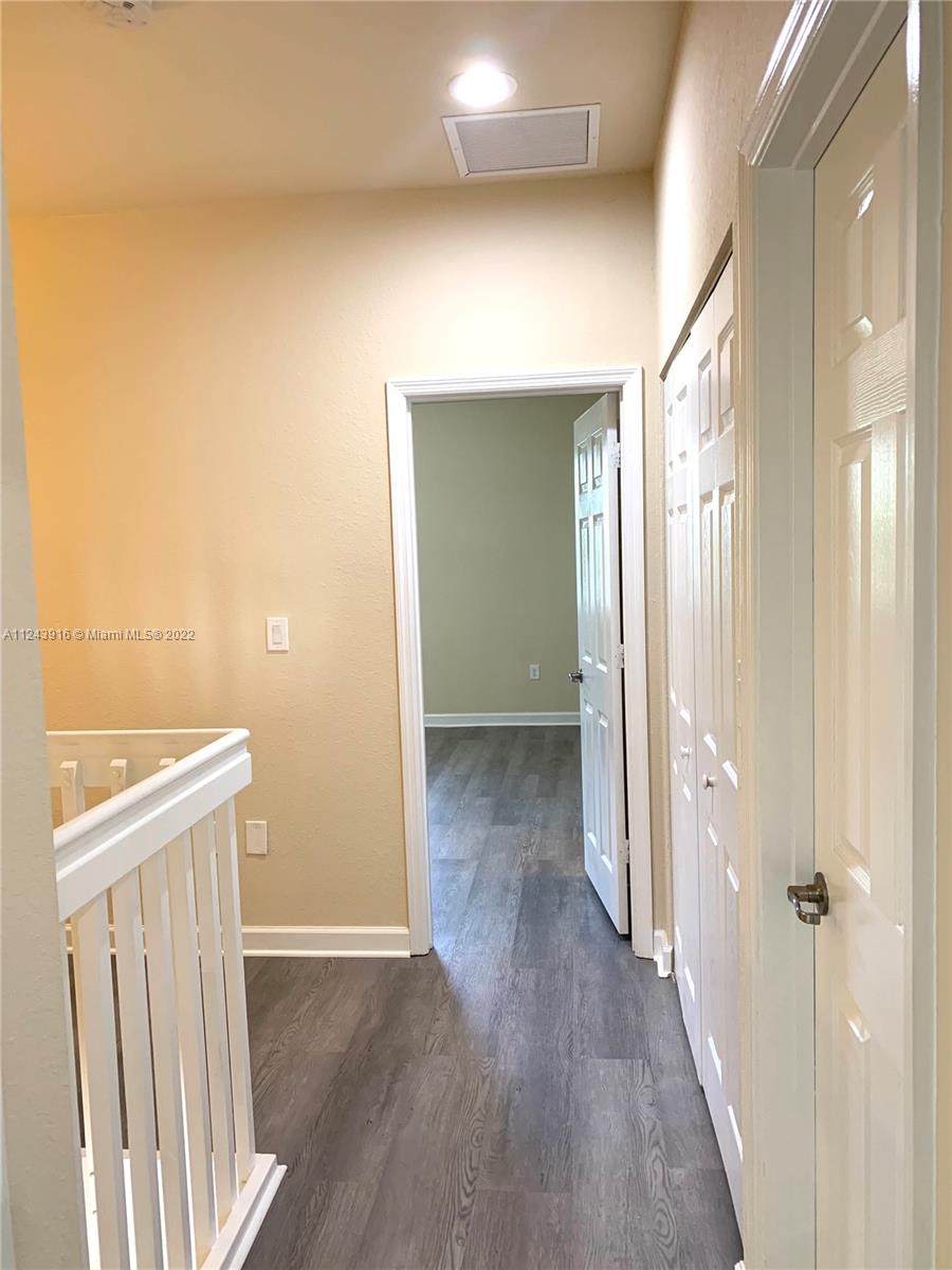16952 Southwest 90th Street Miami, FL 33196 - Photo 20 of 36 a view of a hallway with wooden floor