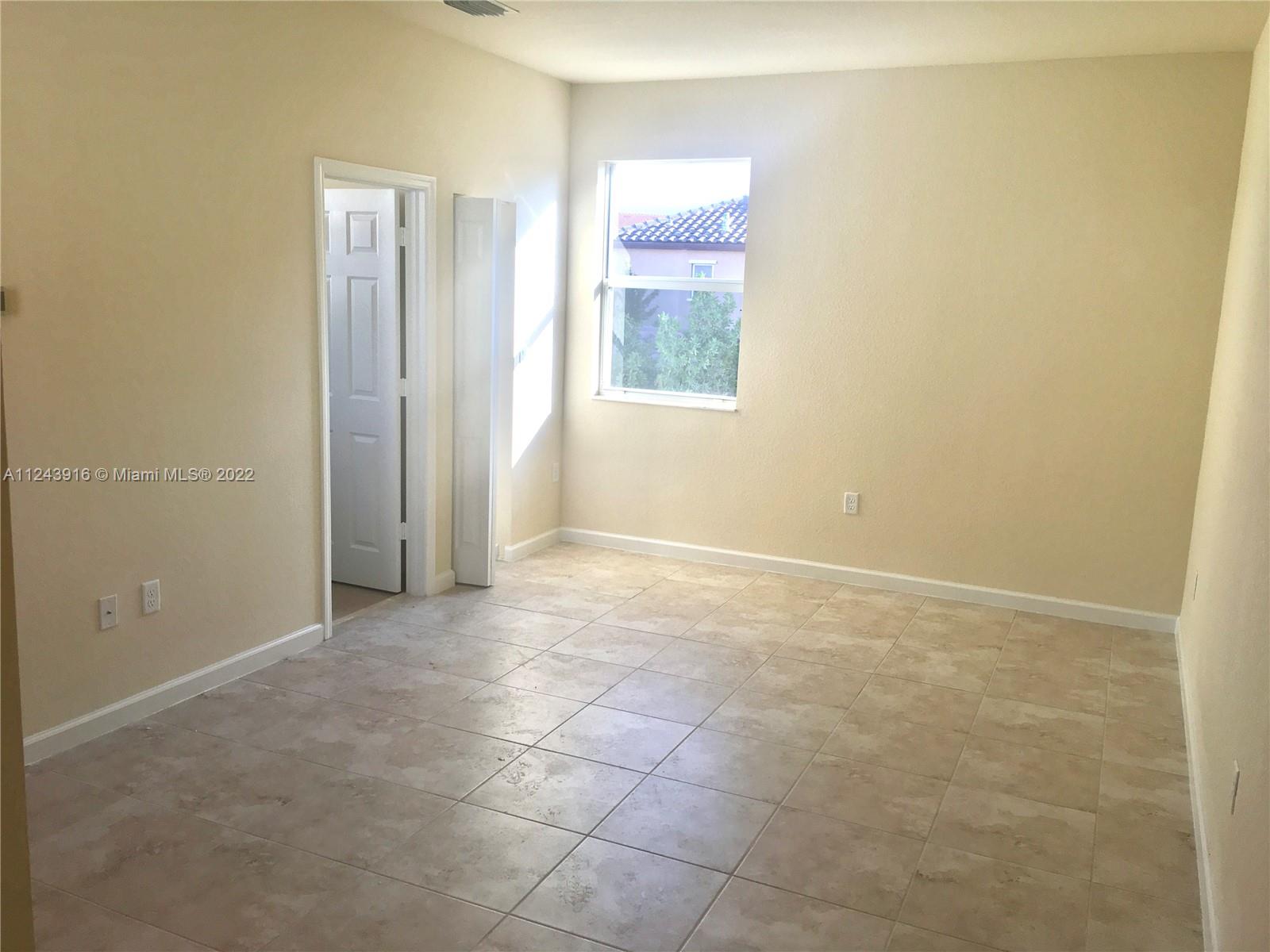 16952 Southwest 90th Street Miami, FL 33196 - Photo 30 of 36 an empty room with windows