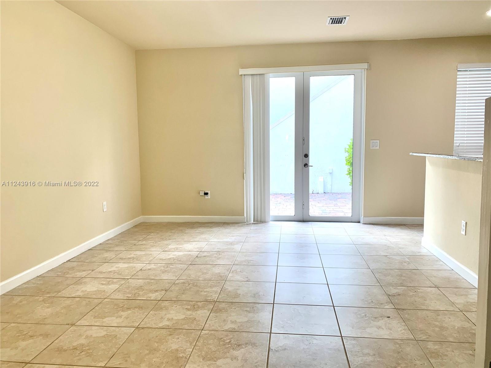 16952 Southwest 90th Street Miami, FL 33196 - Photo 7 of 36 a view of an empty room and window