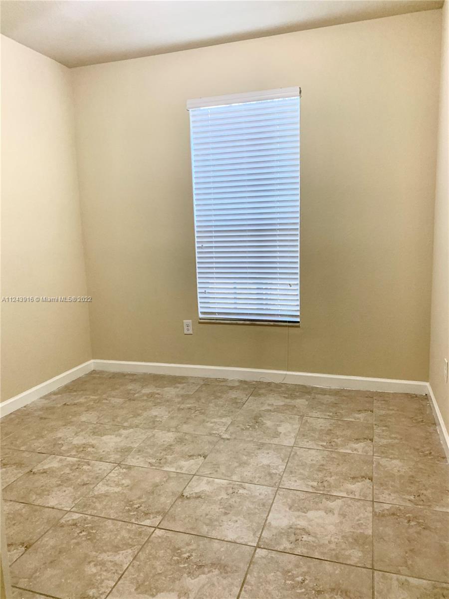16952 Southwest 90th Street Miami, FL 33196 - Photo 9 of 36 a view of an empty room and window