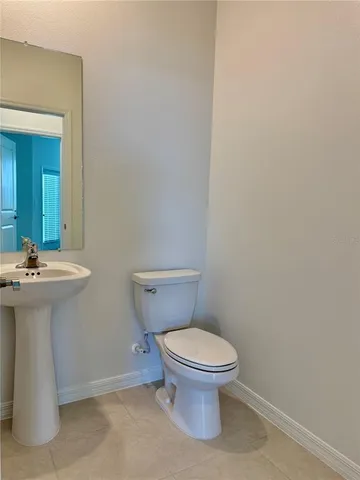 a bathroom with a sink a toilet and mirror