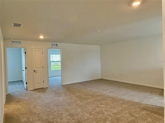 an empty room with closet and bathroom
