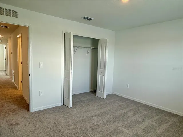 a view of an empty room and closet area