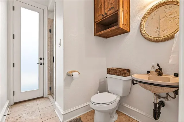 a bathroom with a toilet a sink and a mirror