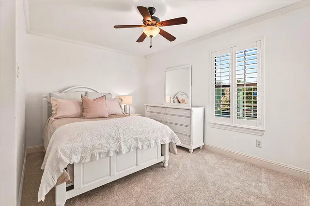 a view of an empty room with cabinet and a ceiling fan