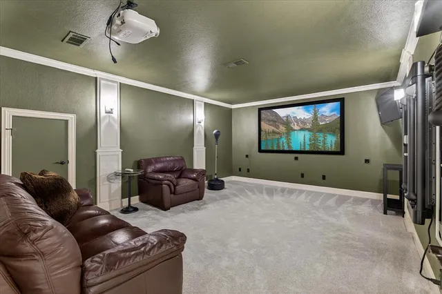 a patio with table and chairs and potted plants