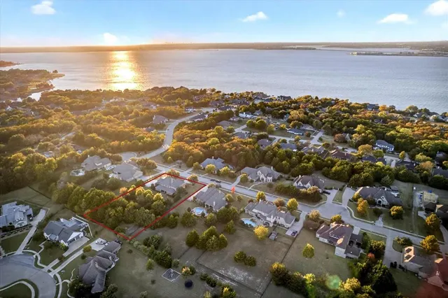 a house view with a garden space and trees