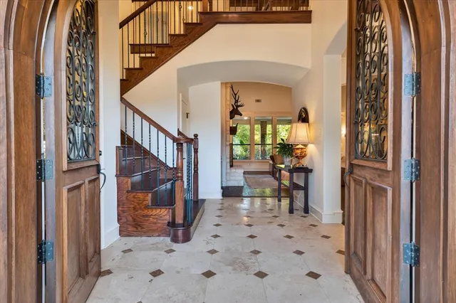 a view of a hallway with wooden floor and a living room