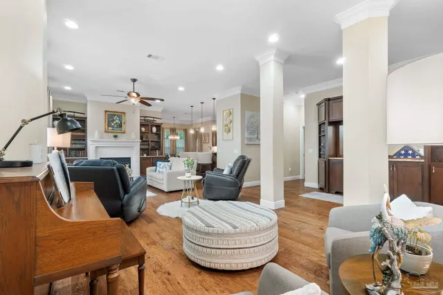 a living room with furniture fireplace and a large window