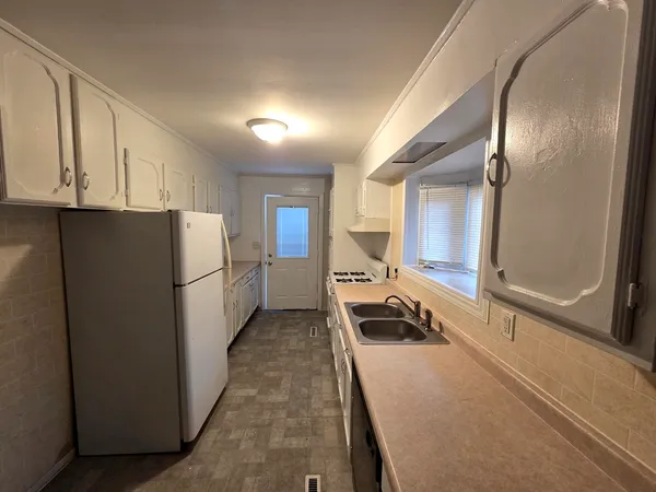 a white refrigerator freezer sitting inside of a kitchen