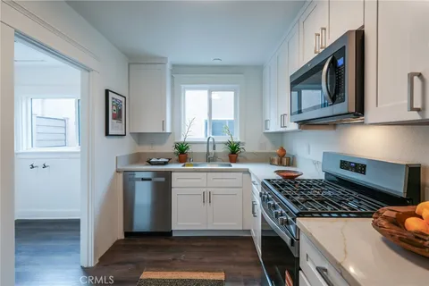 a kitchen with stainless steel appliances granite countertop a stove and a microwave