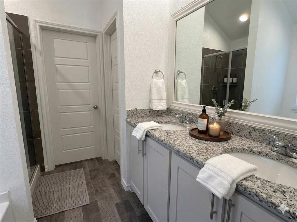 3149 Guyana Road Fort Worth, TX 76123 - Photo 4 of 9 a bathroom with a granite countertop sink and a mirror