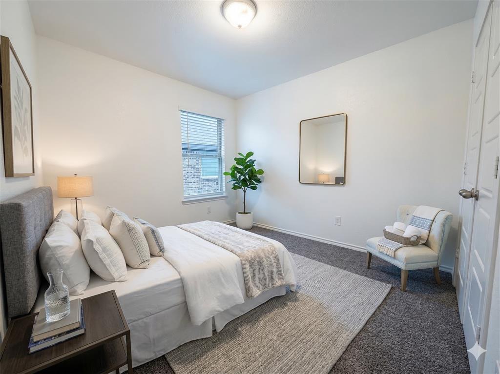 3149 Guyana Road Fort Worth, TX 76123 - Photo 7 of 9 a bedroom with a bed and a lamp
