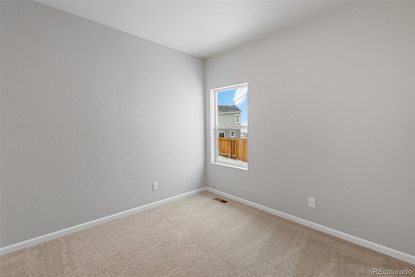 2250 Christina Street Fort Lupton, CO 80621 - Photo 14 of 38 an empty room with windows and a window