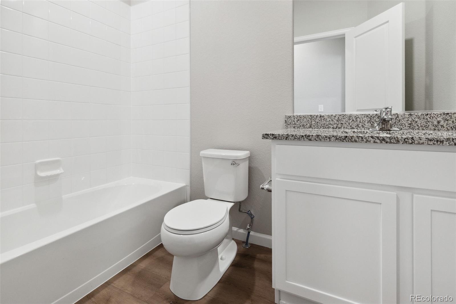 2250 Christina Street Fort Lupton, CO 80621 - Photo 16 of 38 a bathroom with a toilet and a bathtub