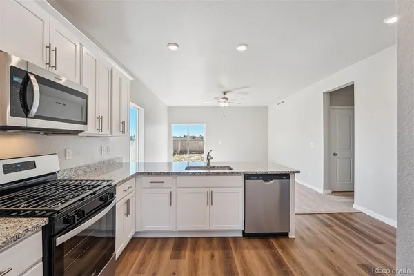 a kitchen with stainless steel appliances granite countertop a stove and a sink