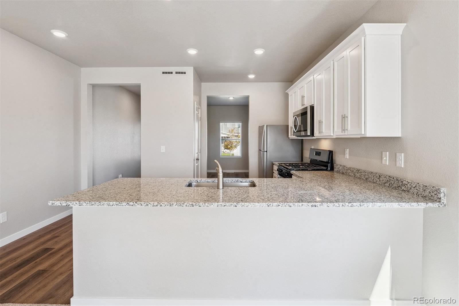 2250 Christina Street Fort Lupton, CO 80621 - Photo 5 of 38 a view of kitchen with granite countertop cabinets and sink