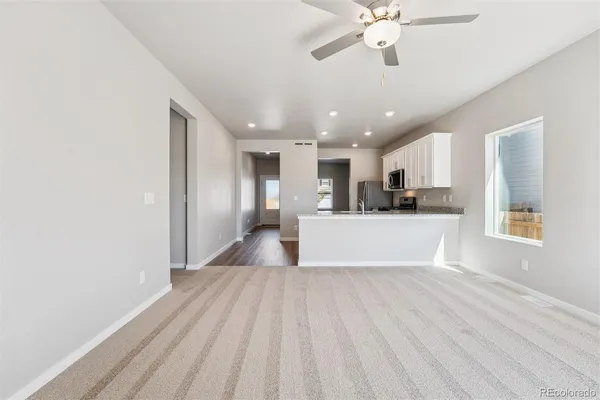 a view of a kitchen with a sink and cabinets