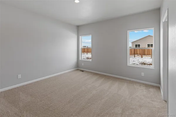 an empty room with windows and closet