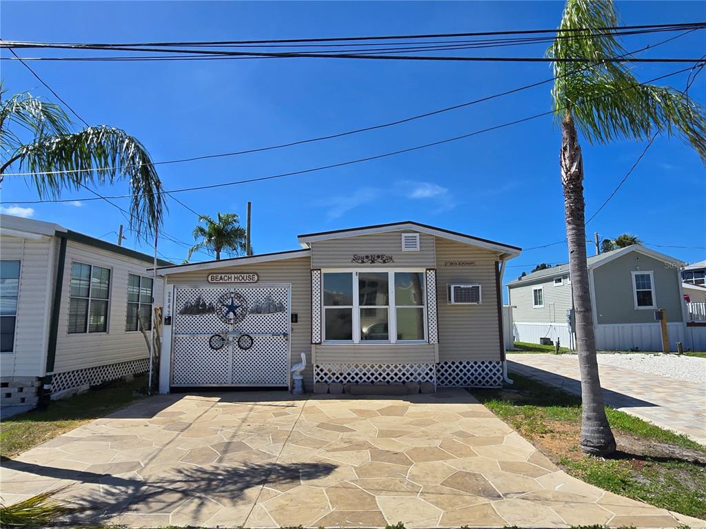 a front view of a house with a yard outdoor seating and garage
