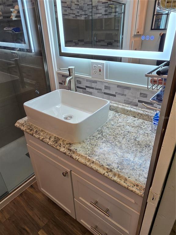 2043 Ketch Circle Palm Harbor, FL 34683 - Photo 14 of 32 a bathroom with a granite countertop sink and a mirror