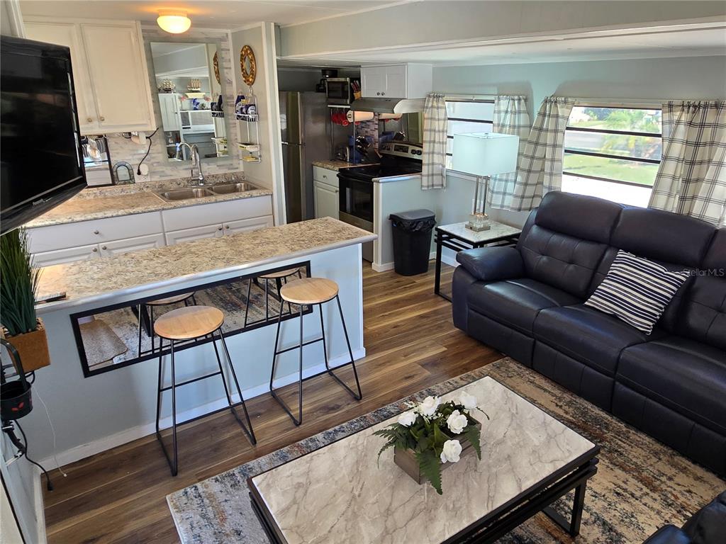 2043 Ketch Circle Palm Harbor, FL 34683 - Photo 5 of 32 a living room with furniture and a flat screen tv