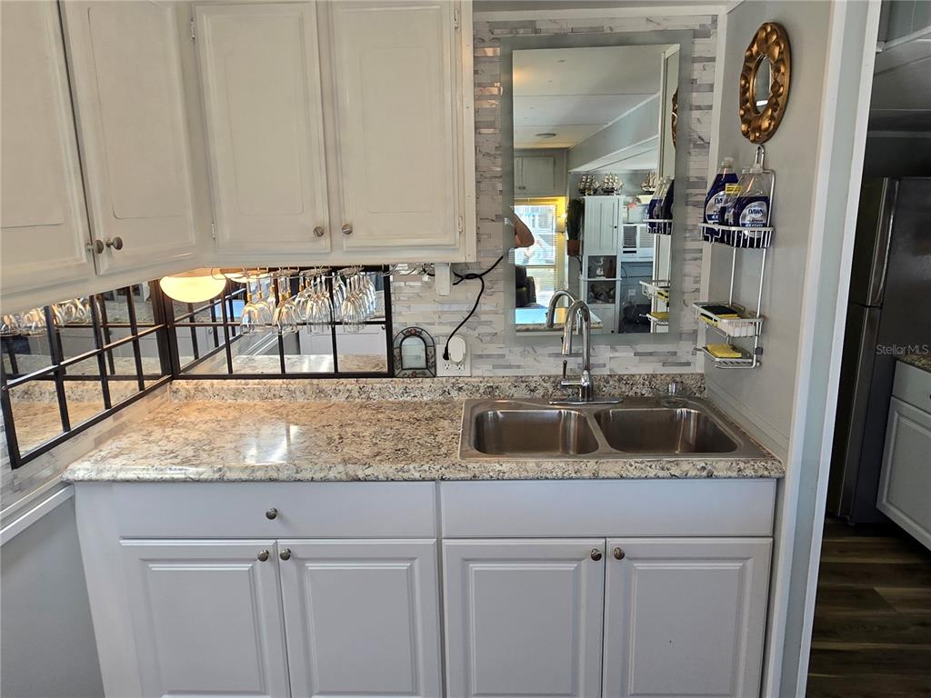 2043 Ketch Circle Palm Harbor, FL 34683 - Photo 7 of 32 a kitchen with a sink and a white cabinets