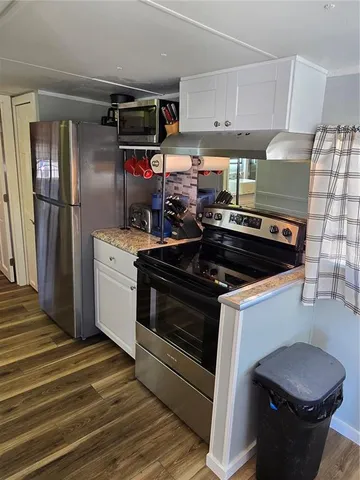 a kitchen with a stove and a refrigerator