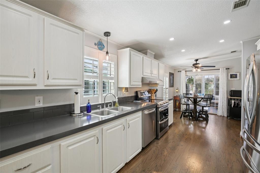 358 Lake Way Oldsmar, FL 34677 - Photo 13 of 48 a kitchen with granite countertop a sink a counter top space stainless steel appliances and cabinets