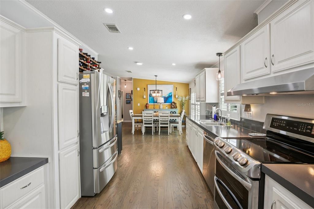 358 Lake Way Oldsmar, FL 34677 - Photo 14 of 48 a kitchen with stainless steel appliances a refrigerator a sink and wooden cabinets