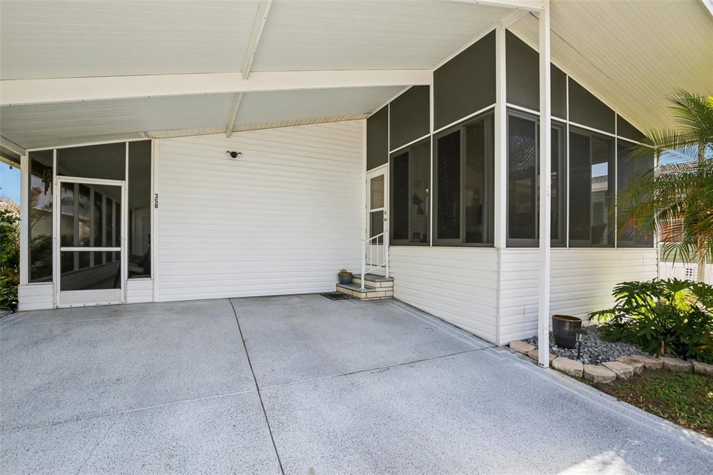 358 Lake Way Oldsmar, FL 34677 - Photo 2 of 48 a view of a house with a large window and potted plants