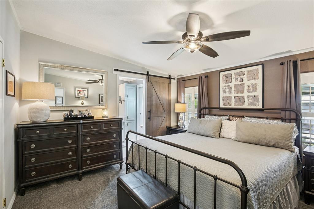 358 Lake Way Oldsmar, FL 34677 - Photo 25 of 48 a bedroom with a bed and a chandelier