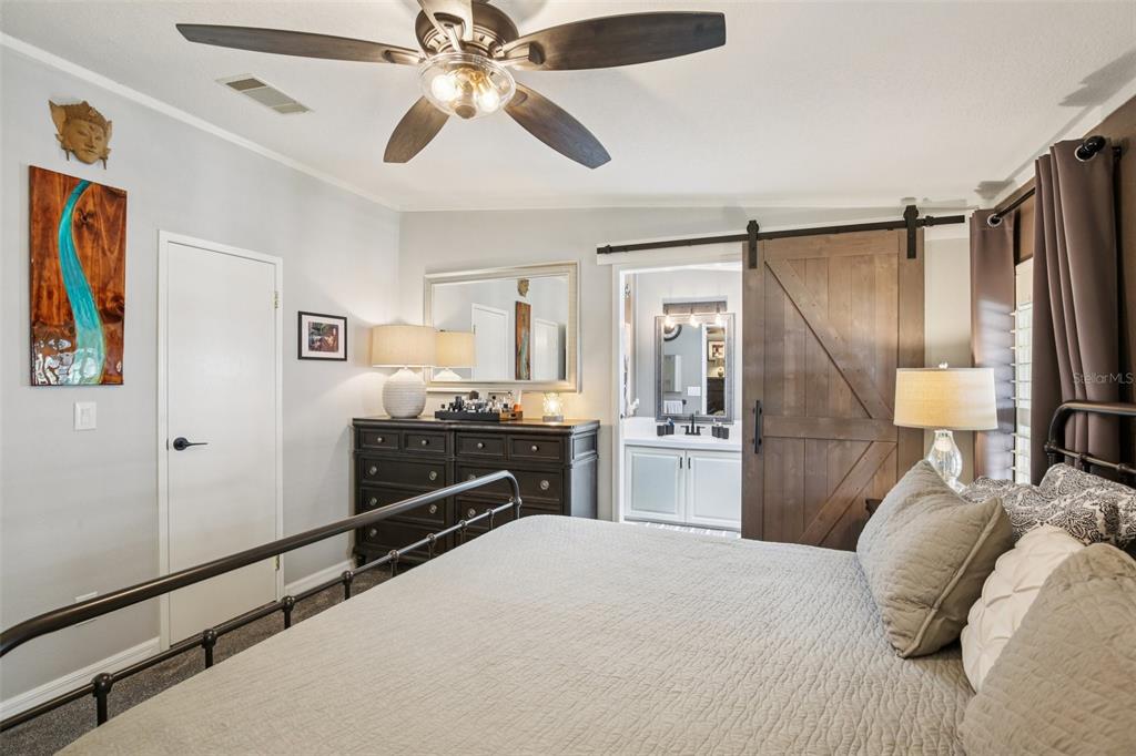 358 Lake Way Oldsmar, FL 34677 - Photo 27 of 48 a bedroom with a bed and a chandelier